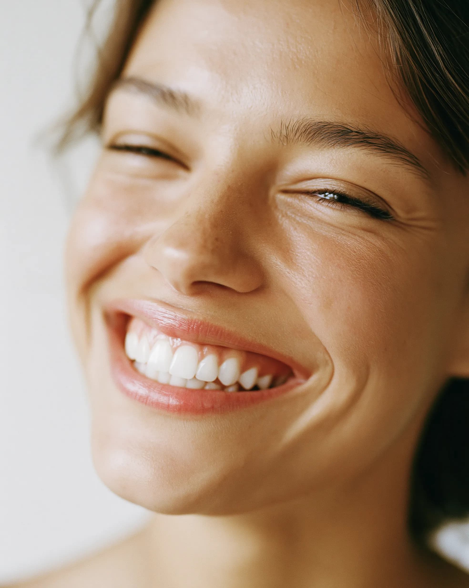 A natural, radiant smile in soft daylight